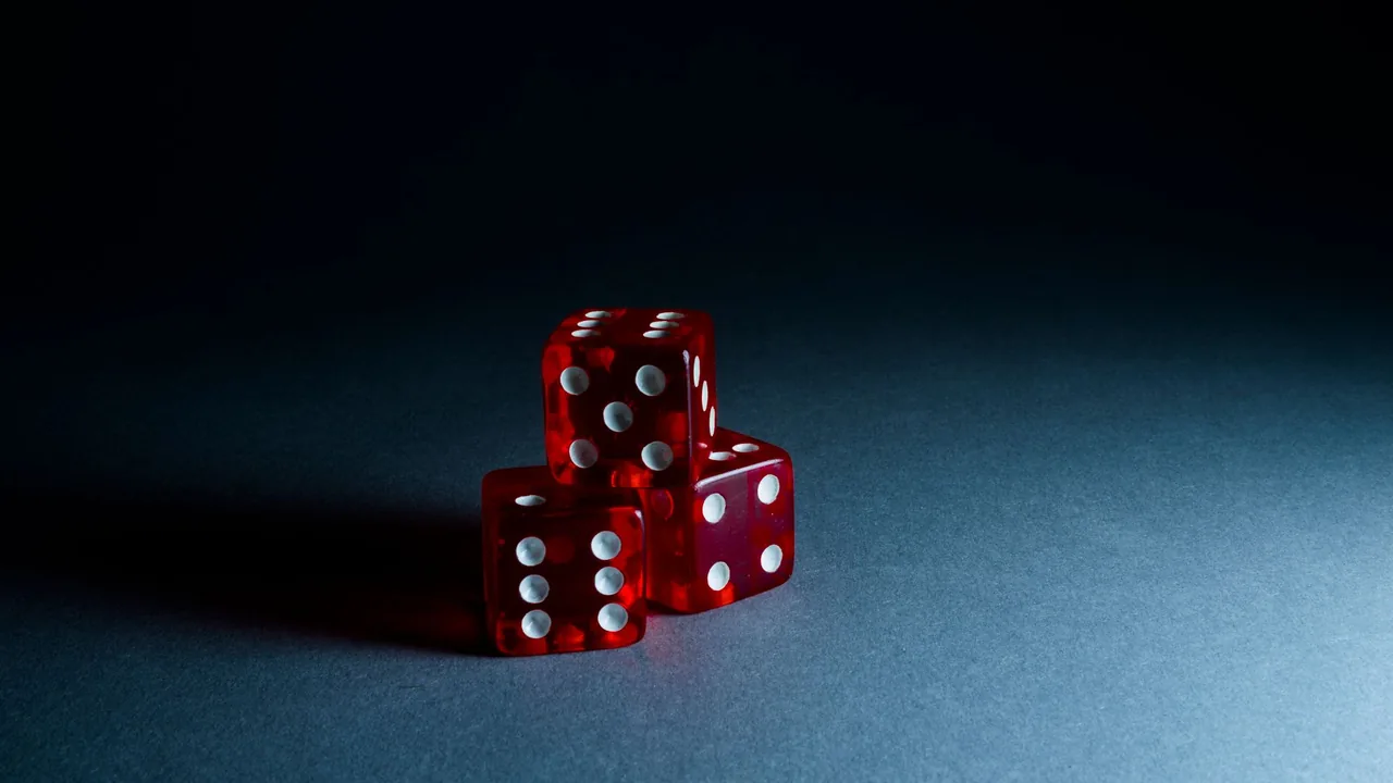 Dice and a coin on a table representing chance.
